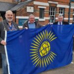 Photo of Councillors holding the Commonwealth Flag